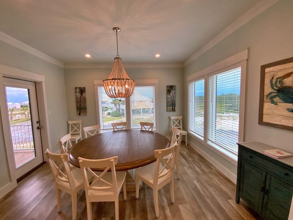 Large dining table with incredible sunset views comfortably seats 10.