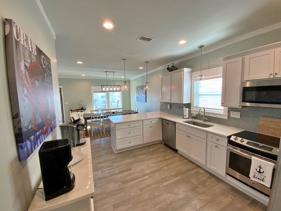 Kitchen - Quartz countertops and stainless appliances featured in this custom kitchen.