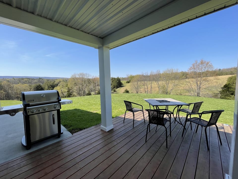Spacious wrap-around deck with grill, fire-table, table and chairs.