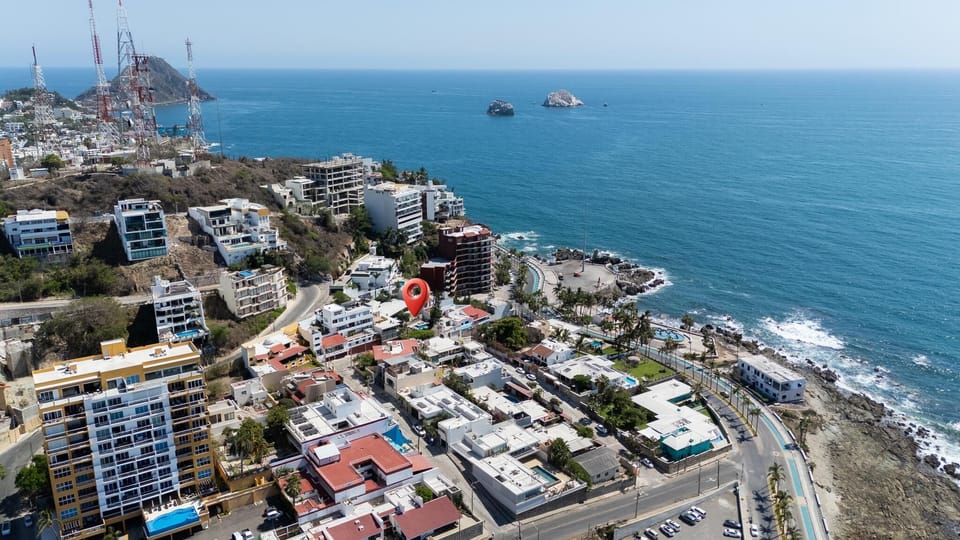 Aerial view of the condo’s location near the coastline, with the Malecon boardwalk and ocean stretching into the horizon.