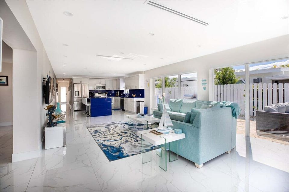 The bright and airy great room offers easy access to both the pool and canal front patio.