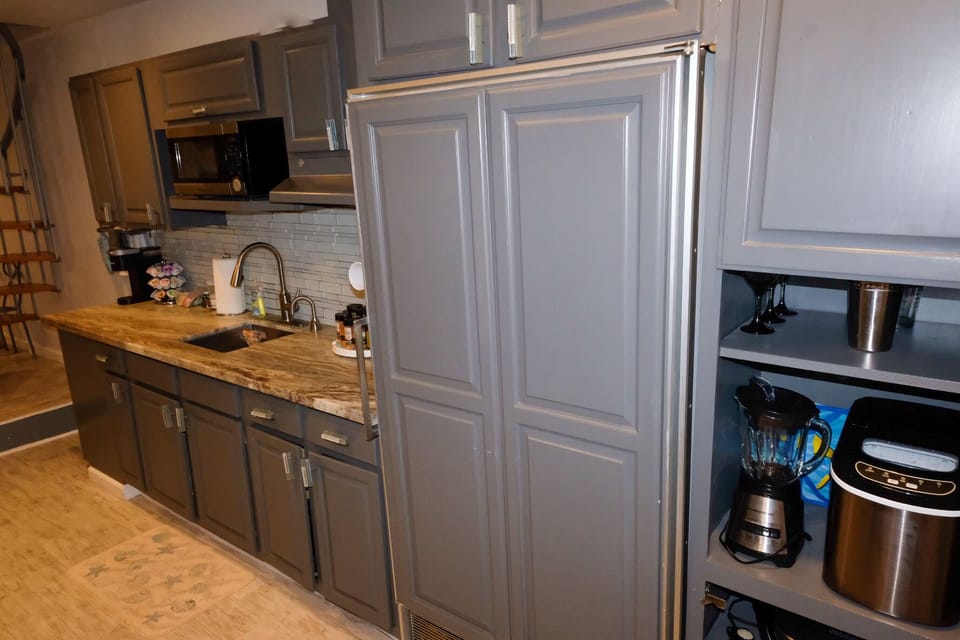 subzero refrigerator with many appliances. also wet seasonings inside. 