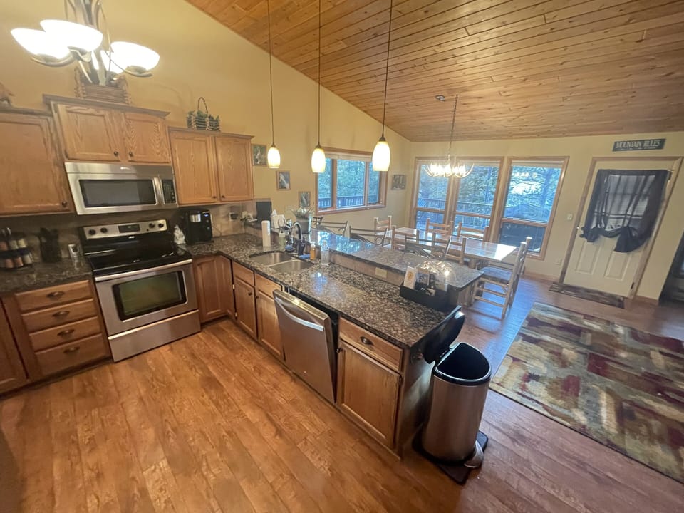 Open kitchen stocked with all the cooking supplies and dinnerware you need!