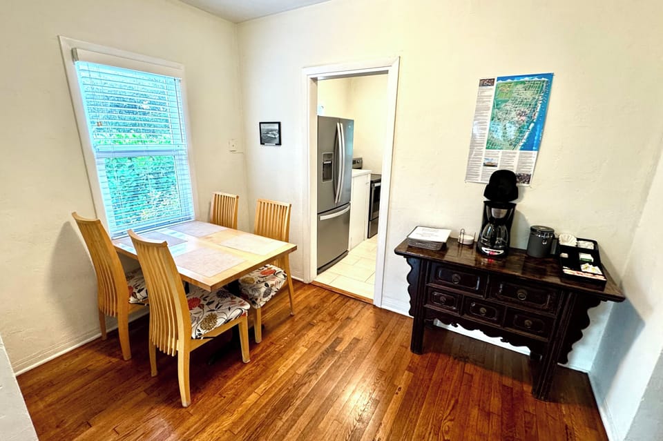 Open-concept living and dining area featuring a cozy electric fireplace