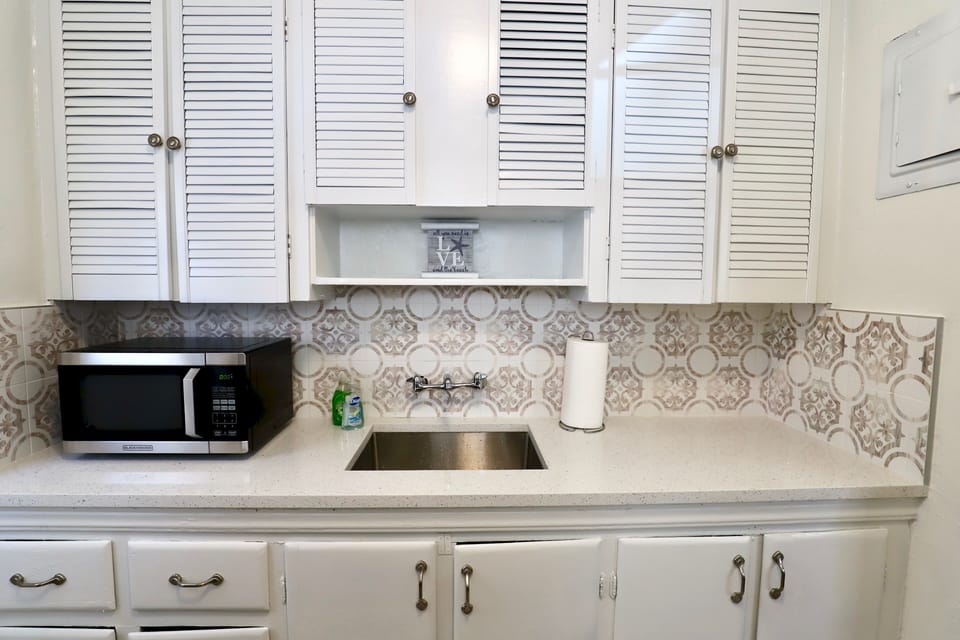 Updated kitchen featuring quartz countertops and stainless steel appliances