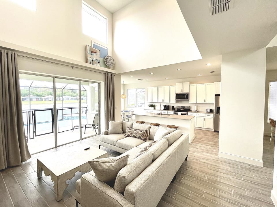 Great Room with 12 foot sliding glass wall opening directly on the pool and lake