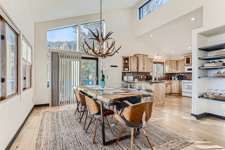(Main Level) Dining Room and Kitchen. The Dining Table is a unique live edge wood table with lots of space for the whole family to dine or work on a puzzle together.