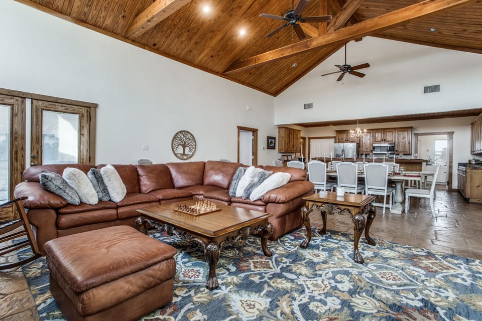 Comfortable open concept living area with beautiful vaulted wood ceilings