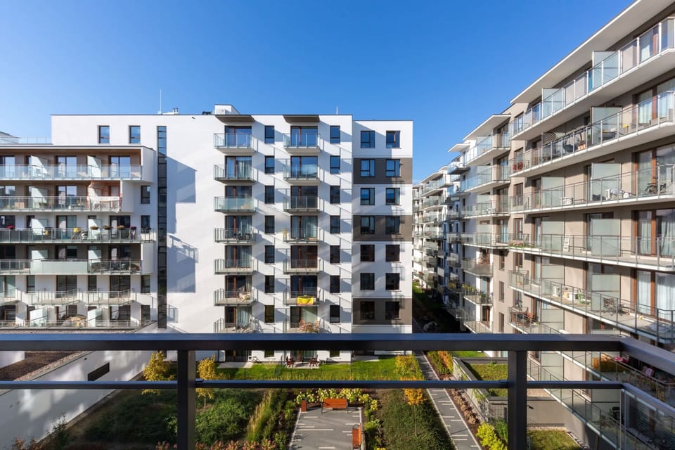 Balcony offering a panoramic view of the modern apartment complex and its surroundings.
