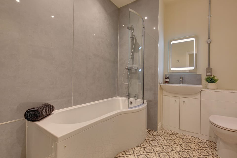 First floor: Bathroom has bath with shower over