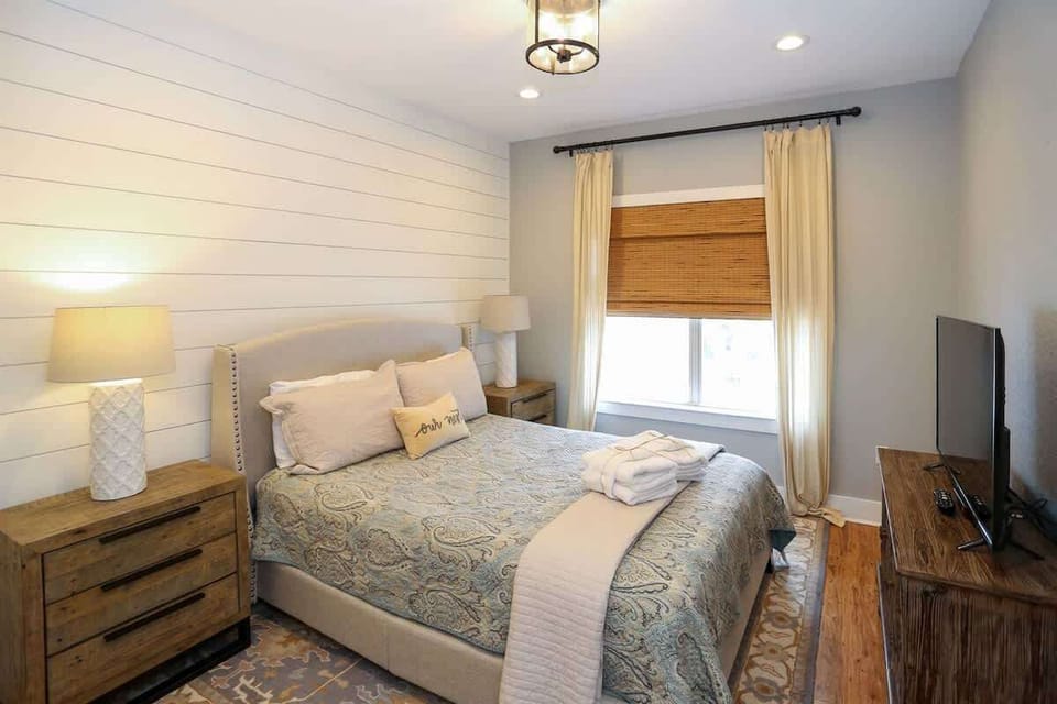 - Soft textiles and a palette of gentle tones make this bedroom effortlessly relaxing - Blackout curtains and a plush mattress, sleep comes easy after a beach day - Thoughtful touches and symmetry give this space a boutique style calm