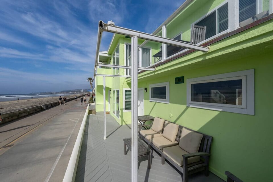 Relax on the oceanfront patio with seating overlooking the boardwalk, beach, and Pacific Ocean.