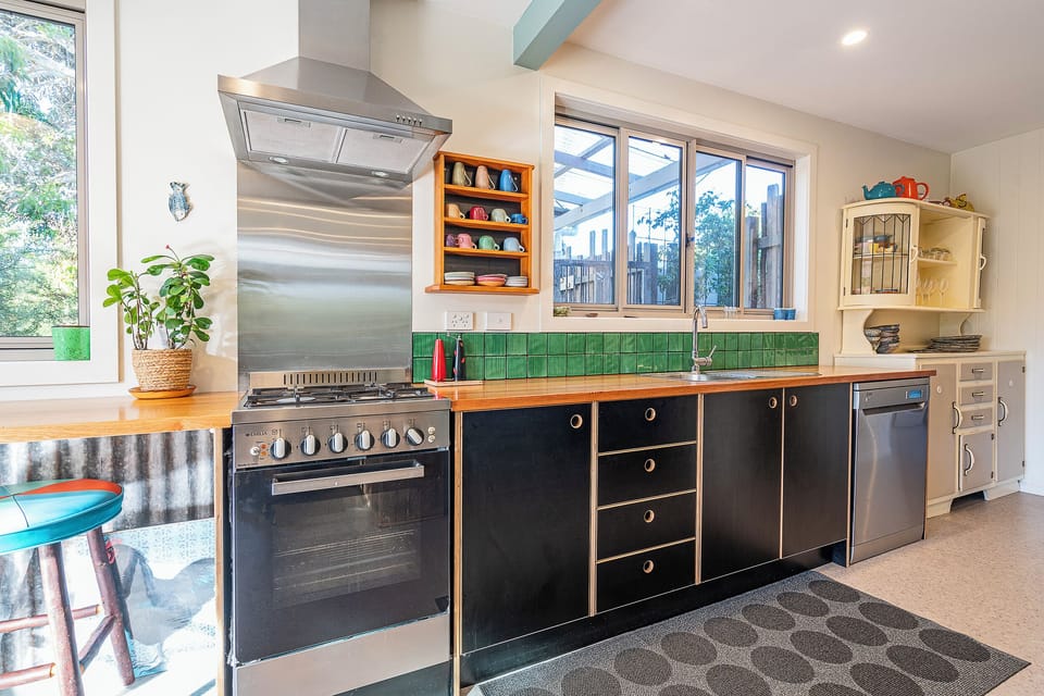 Cook up a storm in the fully-equipped kitchen, complete with modern appliances, benchtop seating, and everything you need.
