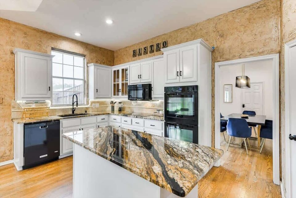 Stylish kitchen with large island and open layout—ideal for group stays, meal prep, and socializing.
