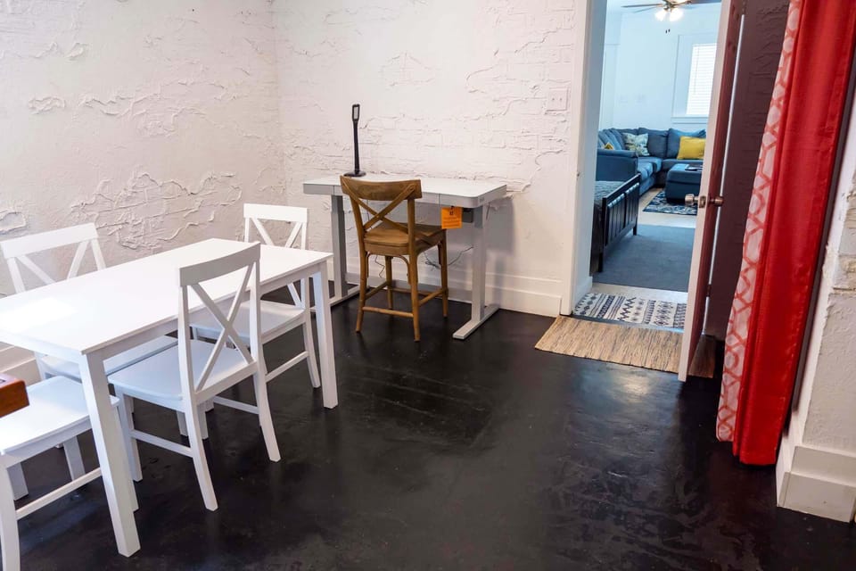 Electronic height adjustable computer desk near wall.