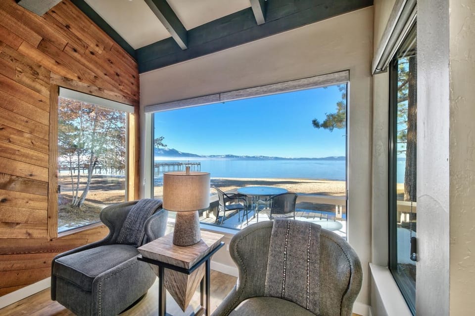 Relax in your cozy living area while taking in stunning lake views through floor-to-ceiling windows. The perfect spot to unwind.