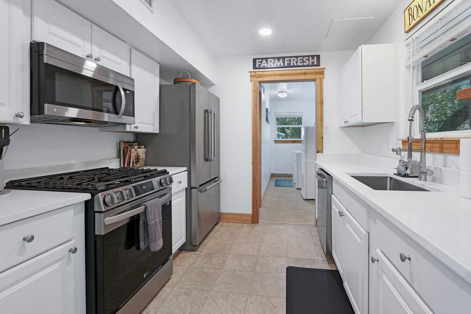 Full kitchen with refrigerator, oven, coffee maker, and microwave
