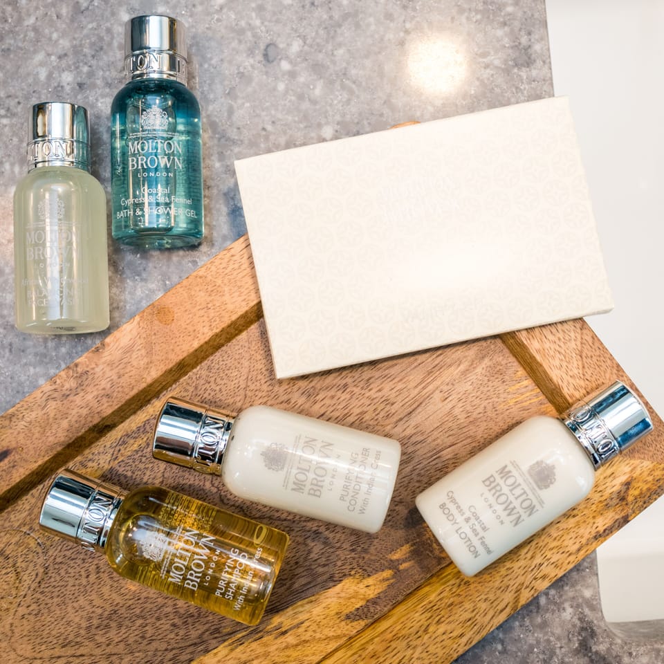 Designer toiletries, hair dryer, bathrobes, towels