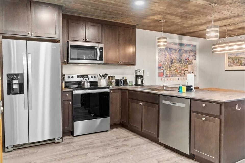 The beautiful kitchen boasts stainless steel appliances, granite countertops, and an open layout keeping you connected with the rest of the group.