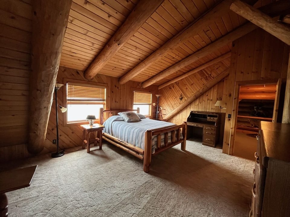 Large master bedroom on second floor, queen sized bed. 