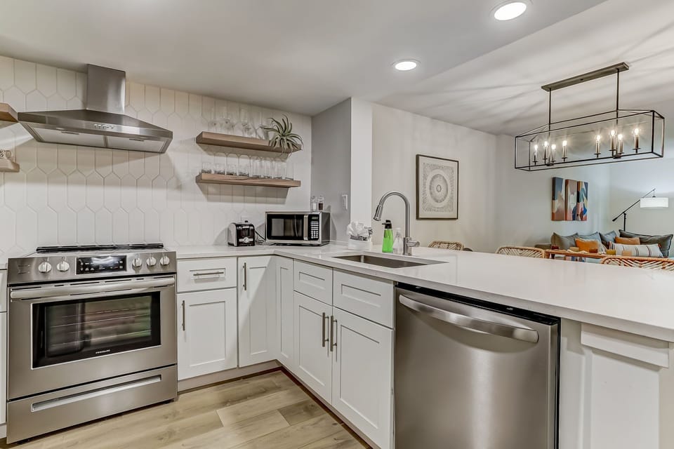 Fully Equipped Kitchen with Stainless Steel Appliances, Beautiful Quartz Countertops, and Open Shelving