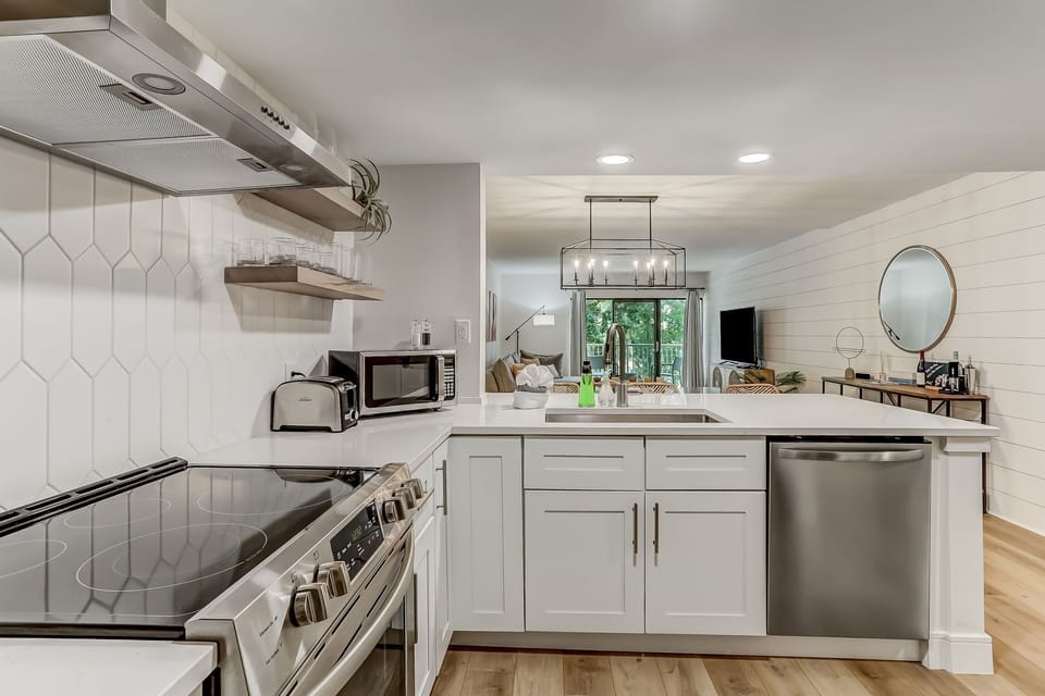 Fully Equipped Kitchen with Stainless Steel Appliances, Beautiful Quartz Countertops, and Open Shelving
