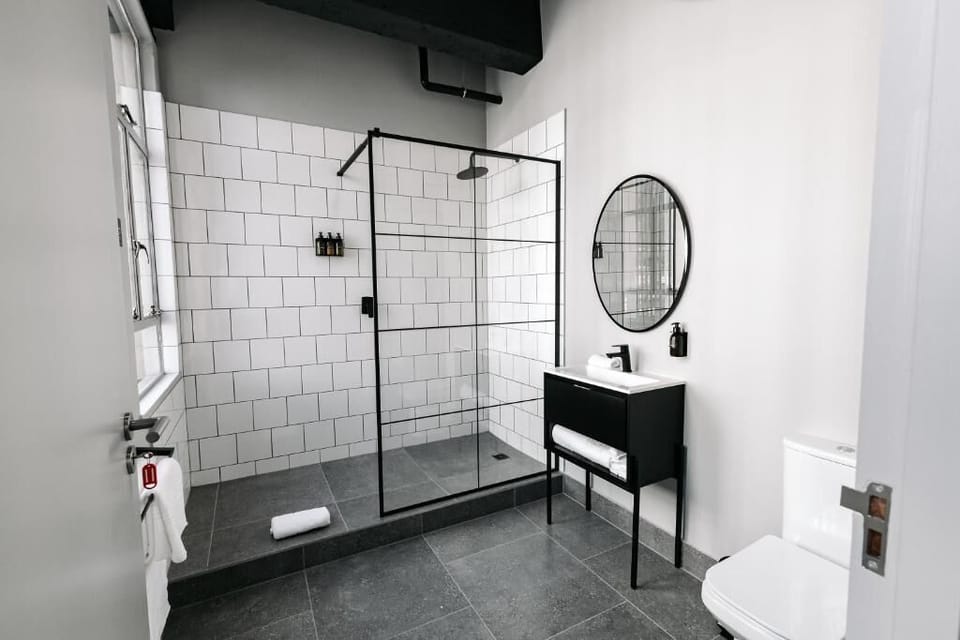 Shower, rainfall showerhead, hair dryer, towels