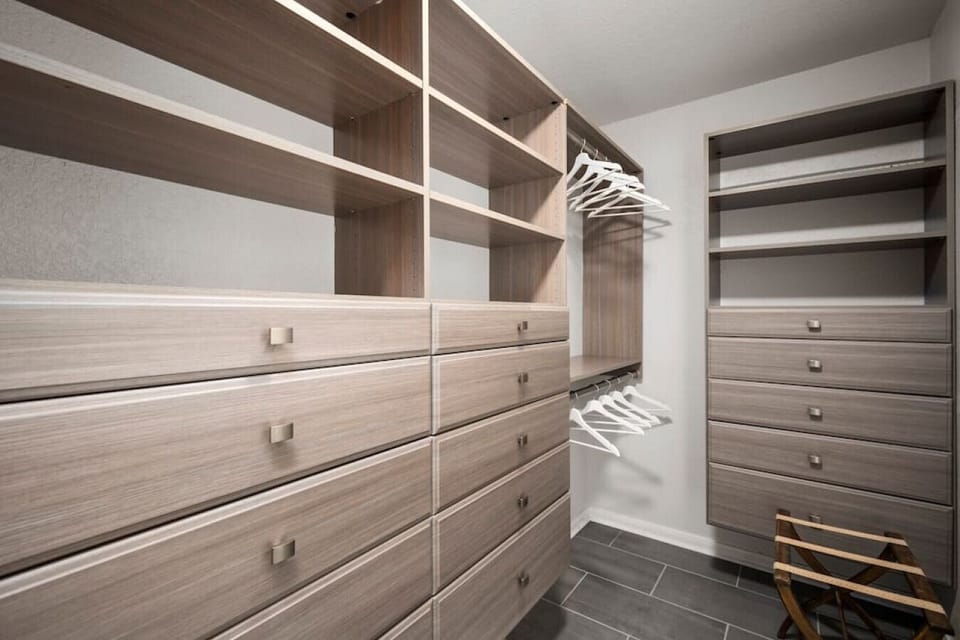 Spacious walk-in closet with built-in drawers and shelving—plenty of room for extended stays.