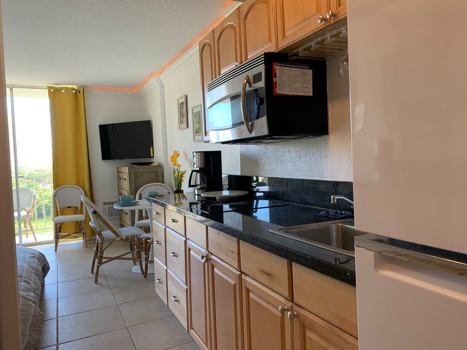 Full kitchen with two burner glass stove top. (no oven) full refrigerator and everything to create and serve your meals at home.