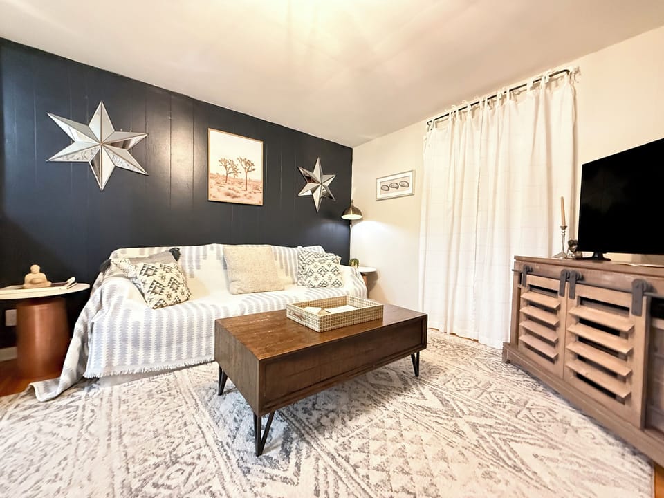 Sit back and relax in our comfortable living space with a plush couch and TV! 