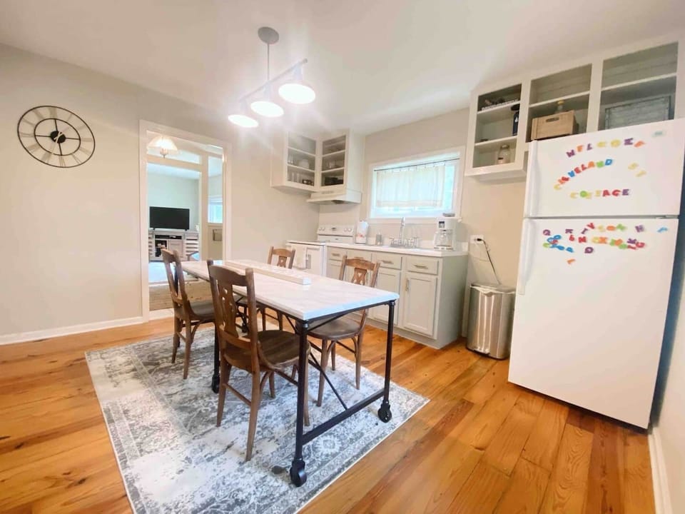 Kitchen area with a full refrigerator, oven, stove, and plenty of seating!