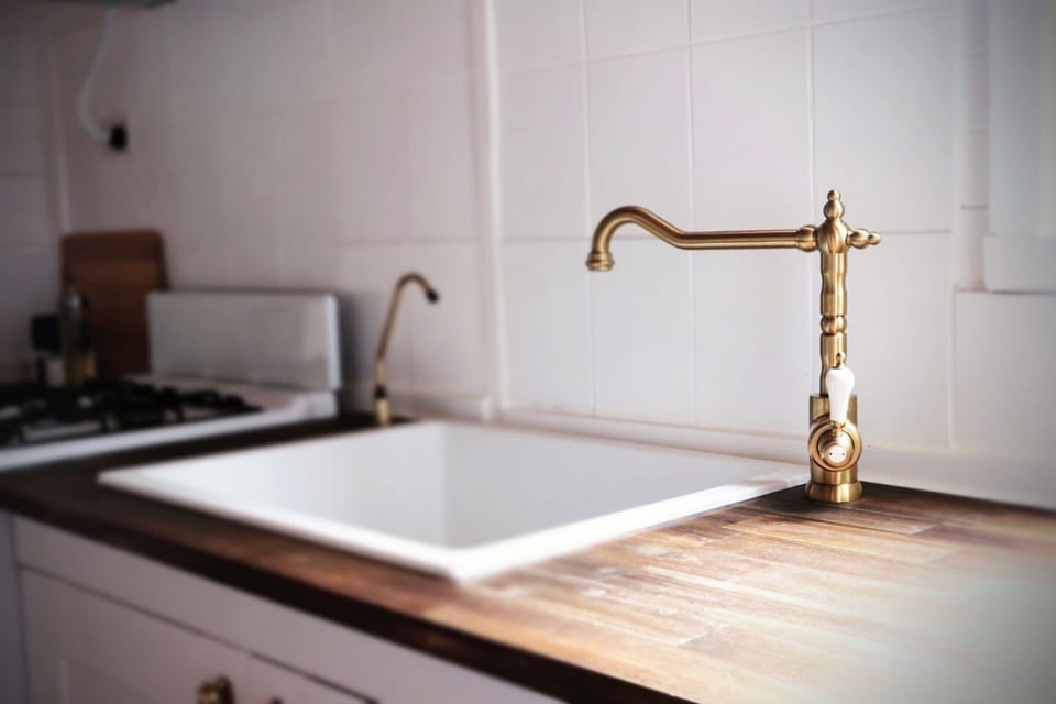 Under sink - cleaning products, paper towel, bin bags, insect spray, foil, wrap
