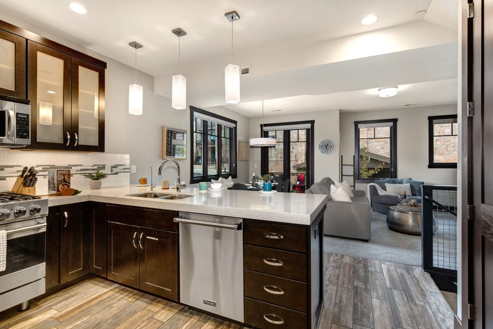 Fully Equipped Kitchen with beautiful stone countertops, stainless steel Viking appliances, and bar seating for four