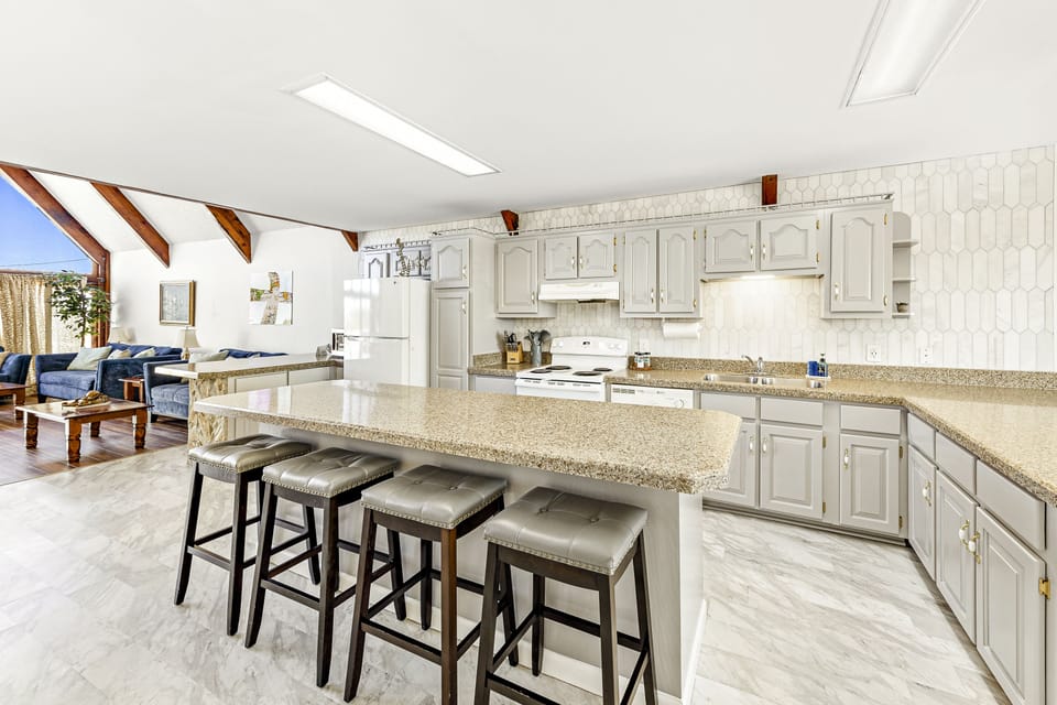 with all the essential cookware, full-sized stove/oven, microwave, and dishwasher.
