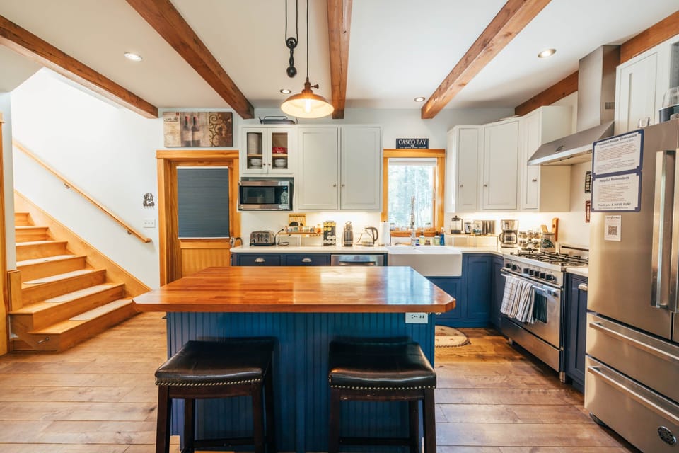 Fully stocked kitchen with an island and wine rack.