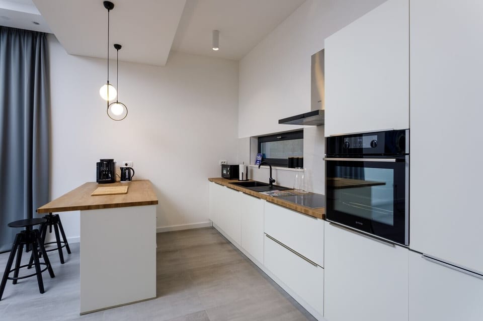 Direct approach toward outdoor dining area, an indoor dining area and a family bathroom with a shower.