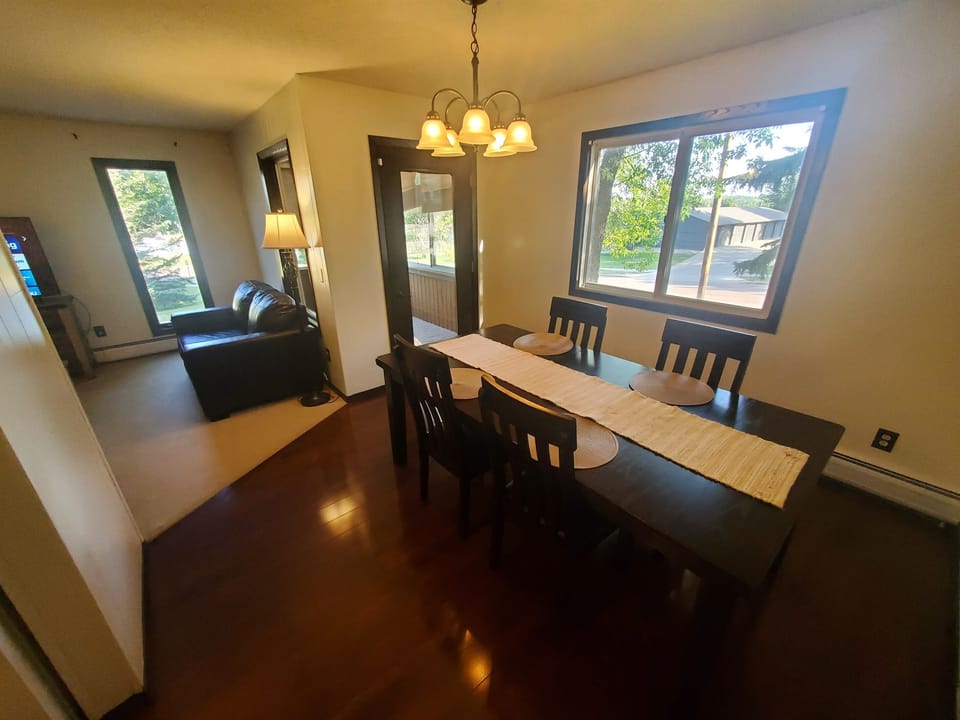KP101APT1 - Dining Room w/ four chairs and place settings and patio access