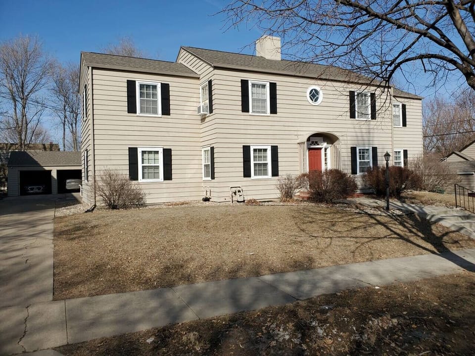 Front Entrace w/security door, lighting, garage and off-street parking behind
