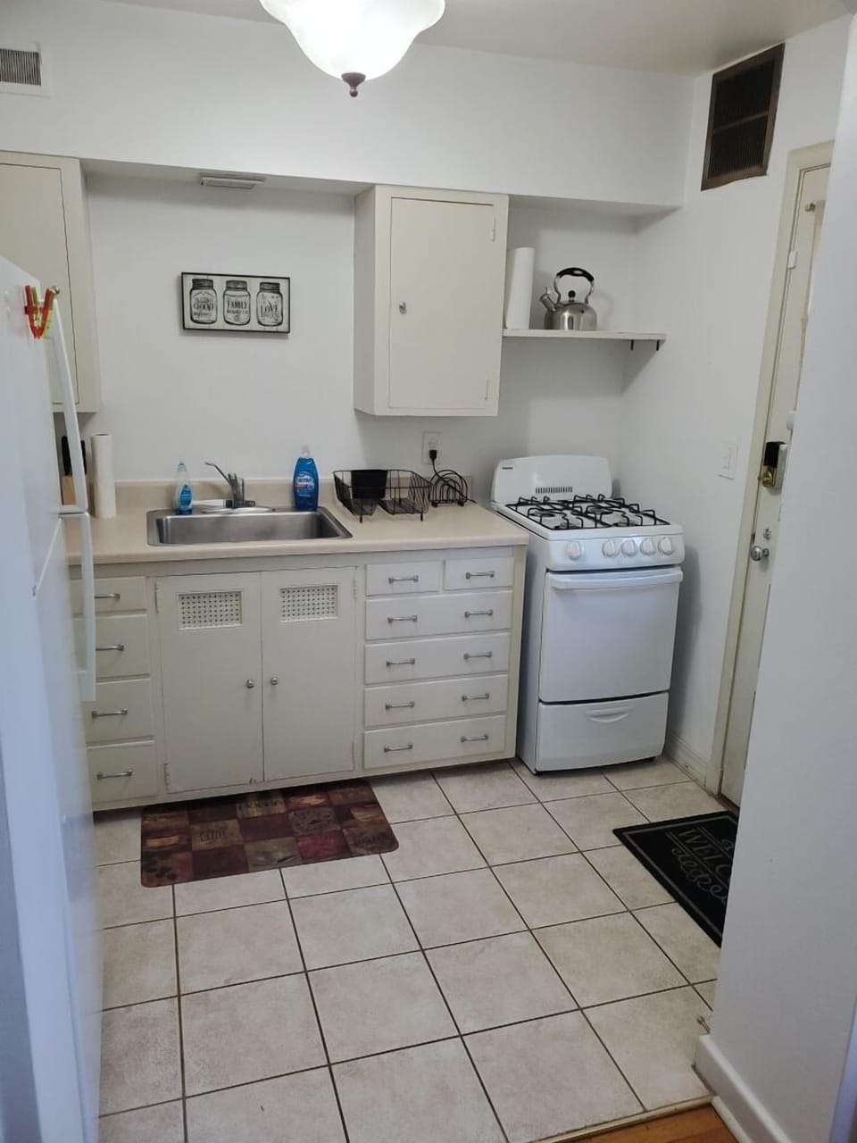 Kitchen w/essentials, microwave, stove, oven, refrigerator, freezer, coffee machine