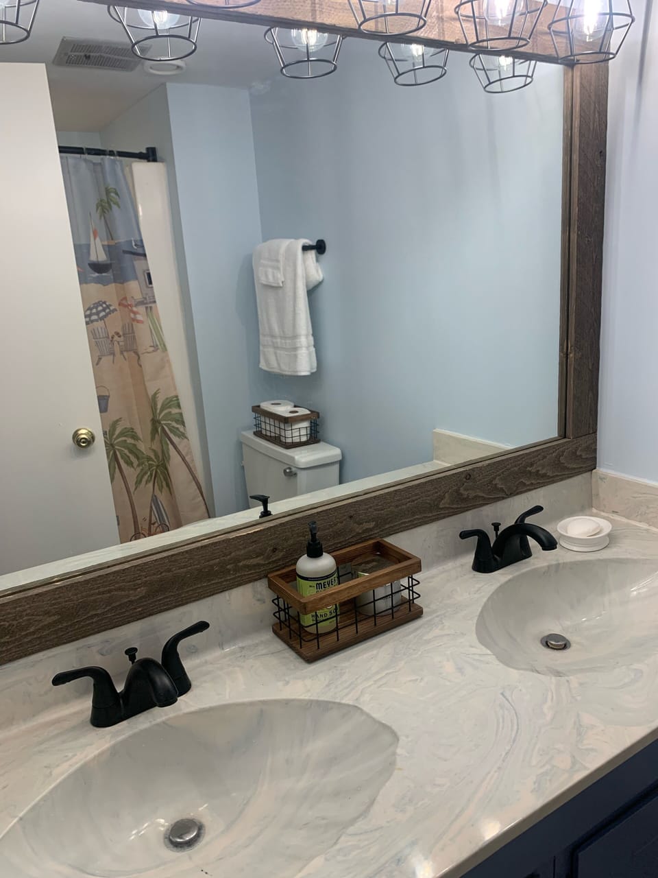 En suite master bathroom with double sinks and shower