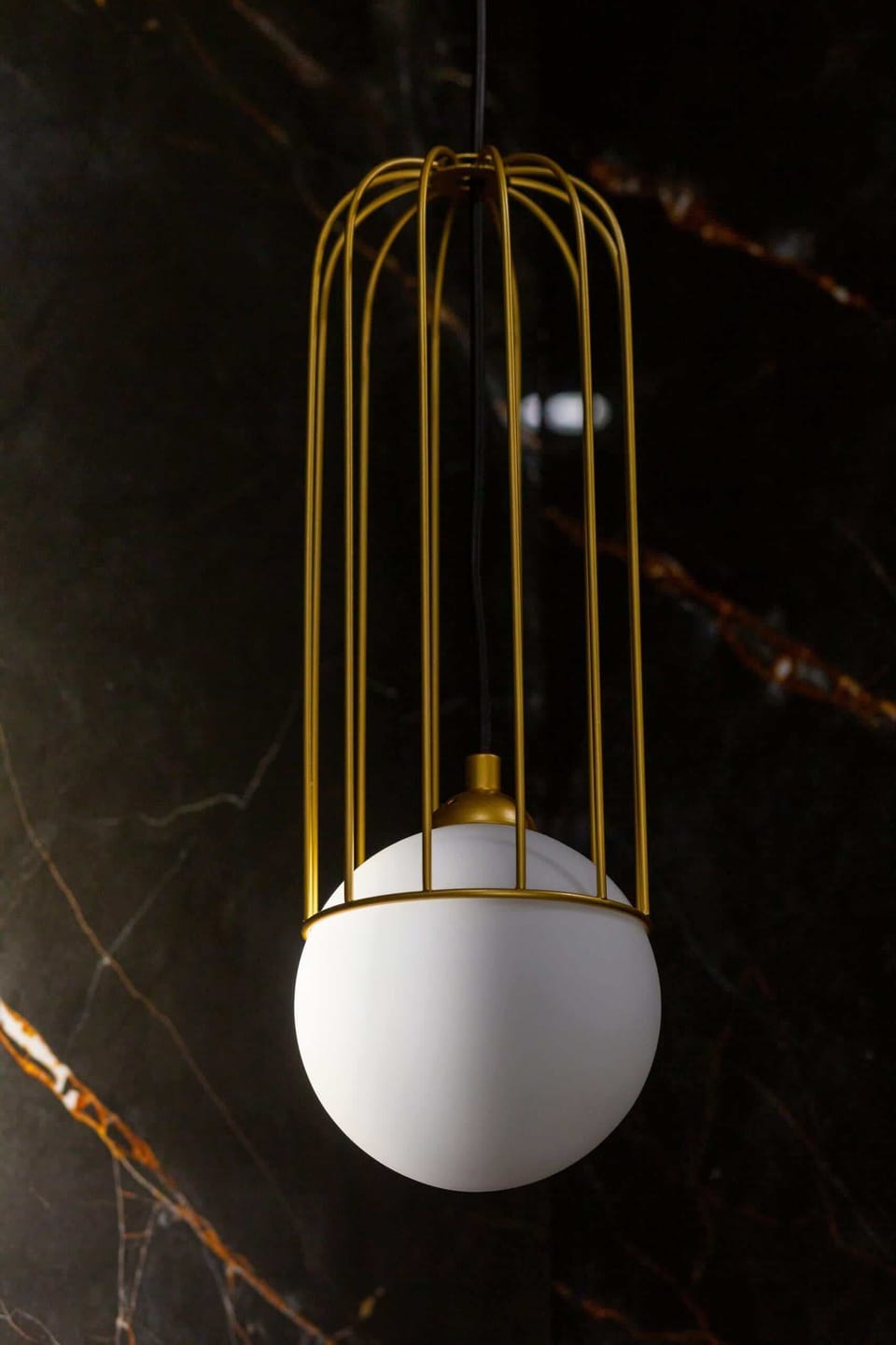 A modern chandelier with gold accents, adding sophistication to the interior.
