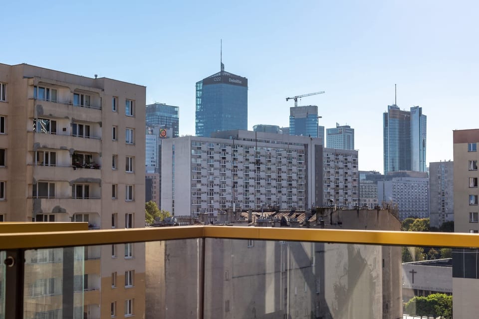 A city view from the apartment, featuring a mix of modern and classic architecture.
