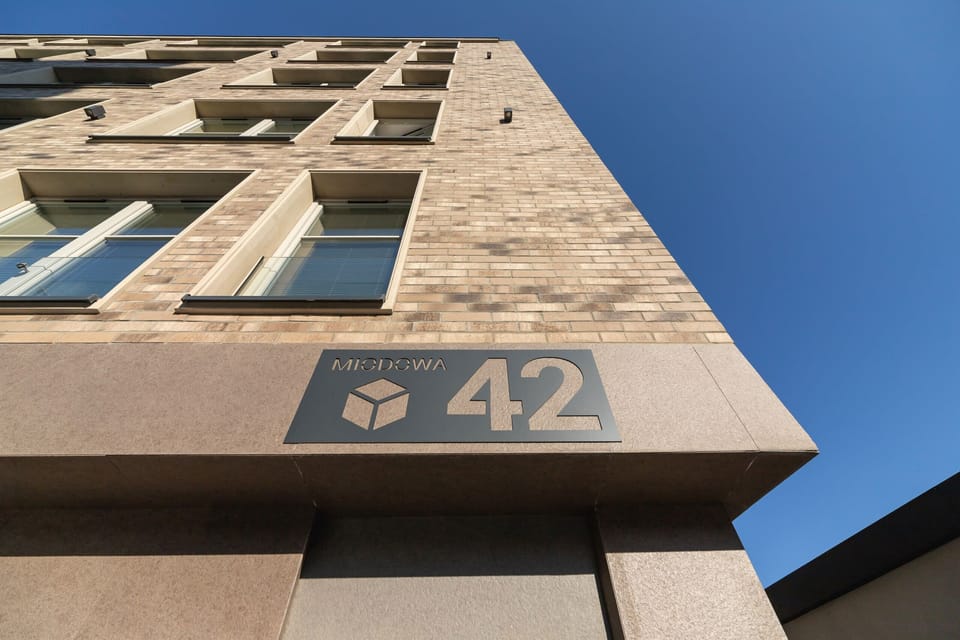 An exterior view of the building with its distinctive architectural number plate.

