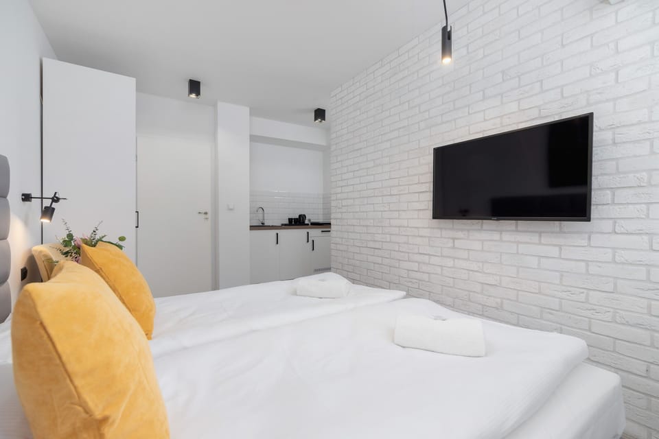 Another perspective of the bedroom showcasing its spacious layout and TV setup.

