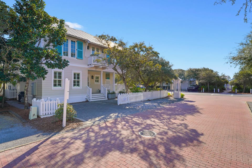 LOCATED ON LARGE CORNER LOT W/PRIVATE DRIVEWAY ACROSS FROM BEACH