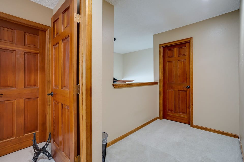 Step into your private hallway featuring beautiful wood doors and trim, creating a warm, homey atmosphere for your stay.
