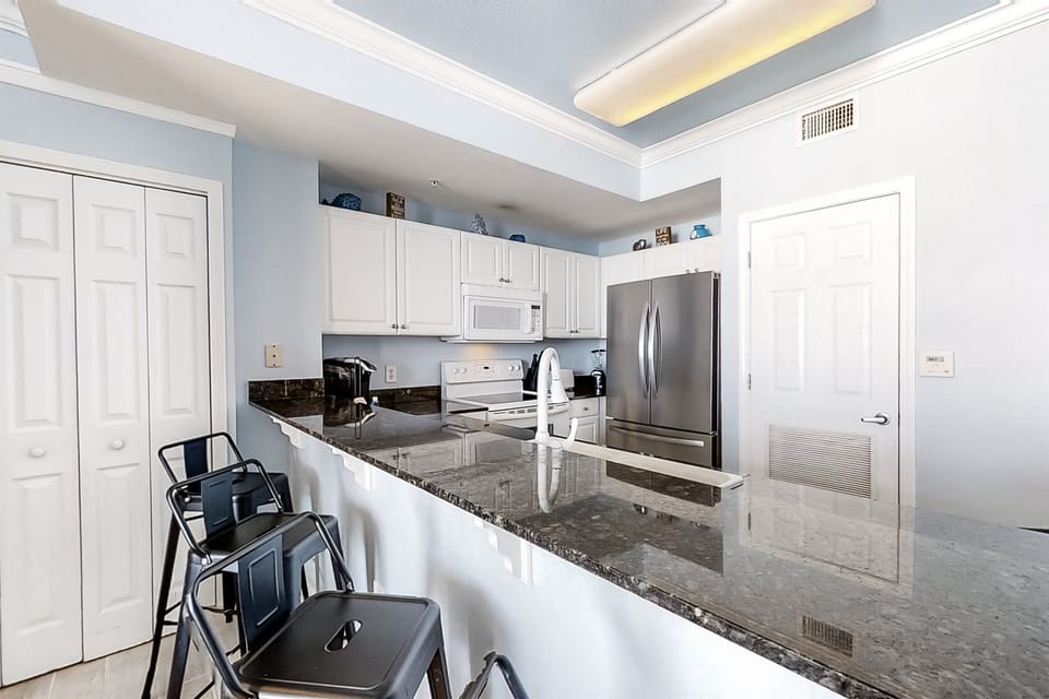 Fully equipped kitchen with granite countertops & ocean breezesKitchen