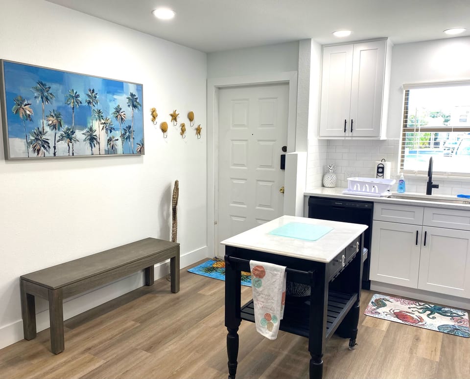The kitchen is open and has an island for meal prep work.