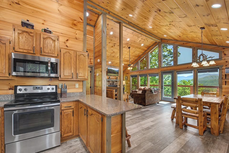 Open kitchen flows into your living and dining area, framed by soaring ceilings and stunning mountain vistas through walls of windows.