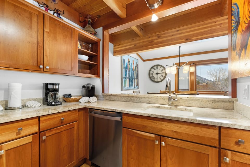 Cook your favorite meals in this warm, fully-equipped kitchen with granite counters and rustic wood beams overhead.